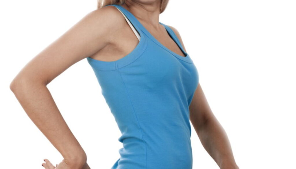 Young happy woman measuring her waist over white background