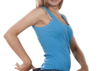 Young happy woman measuring her waist over white background